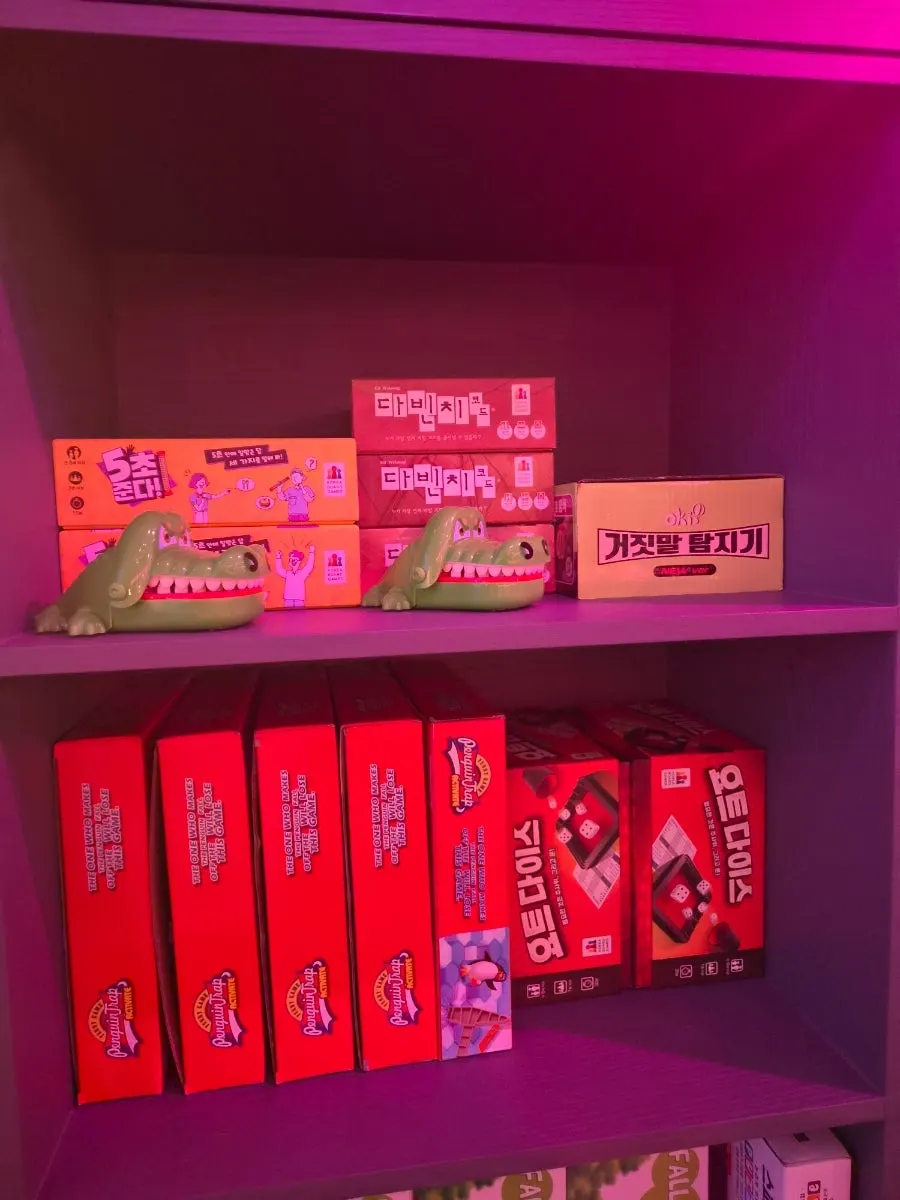 Board games neatly organized on shelves by type