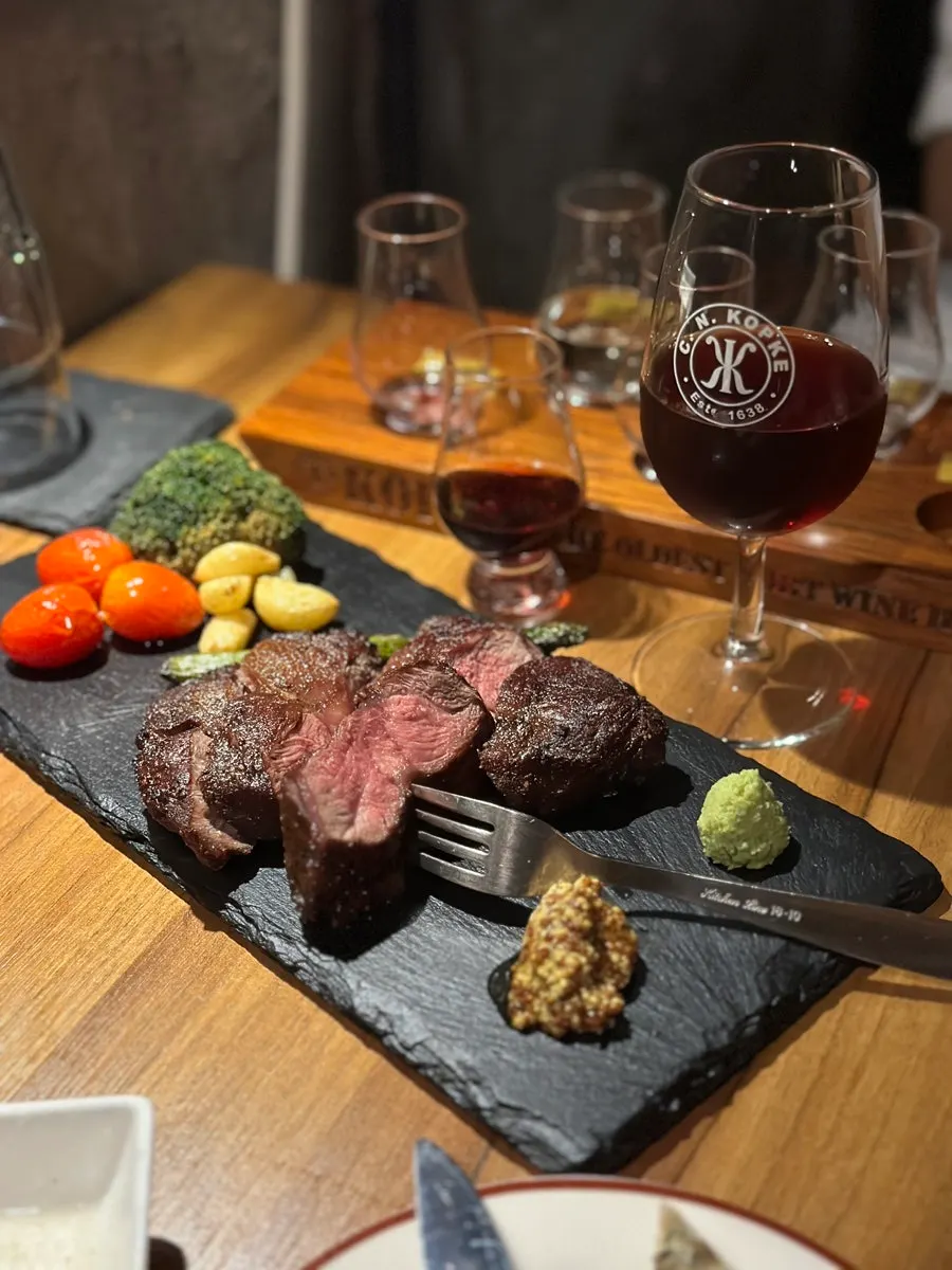 Table with steak and wine together