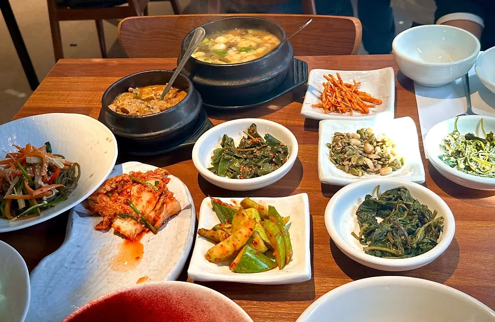 Main course spread with rice, herbs, doenjang, and stew