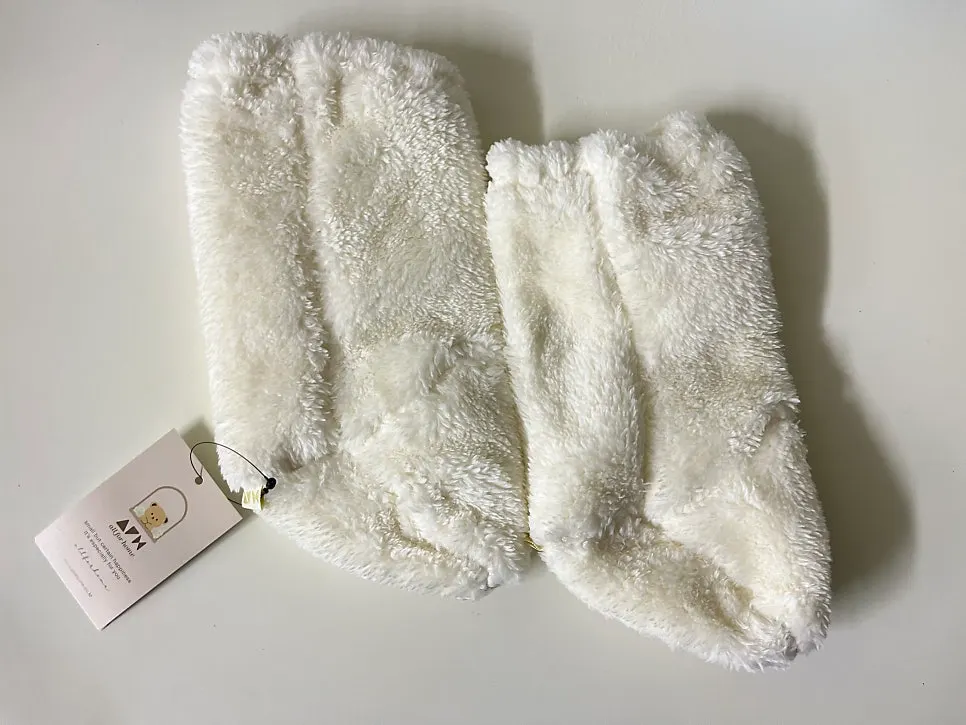 Baby wearing foot warmers that look like shoes