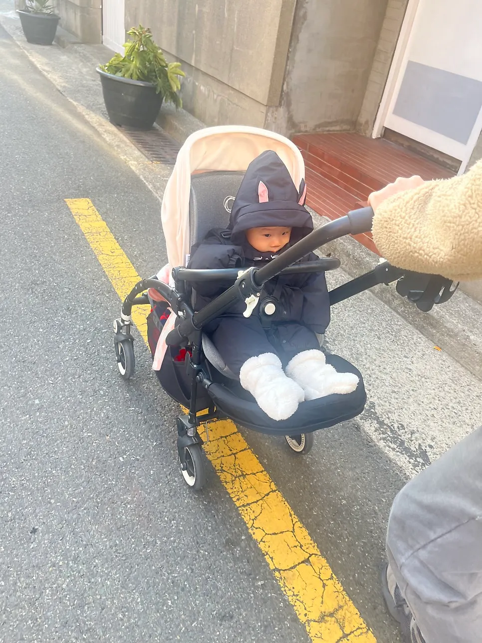 Baby’s first foot-warmer outing in below-zero weather