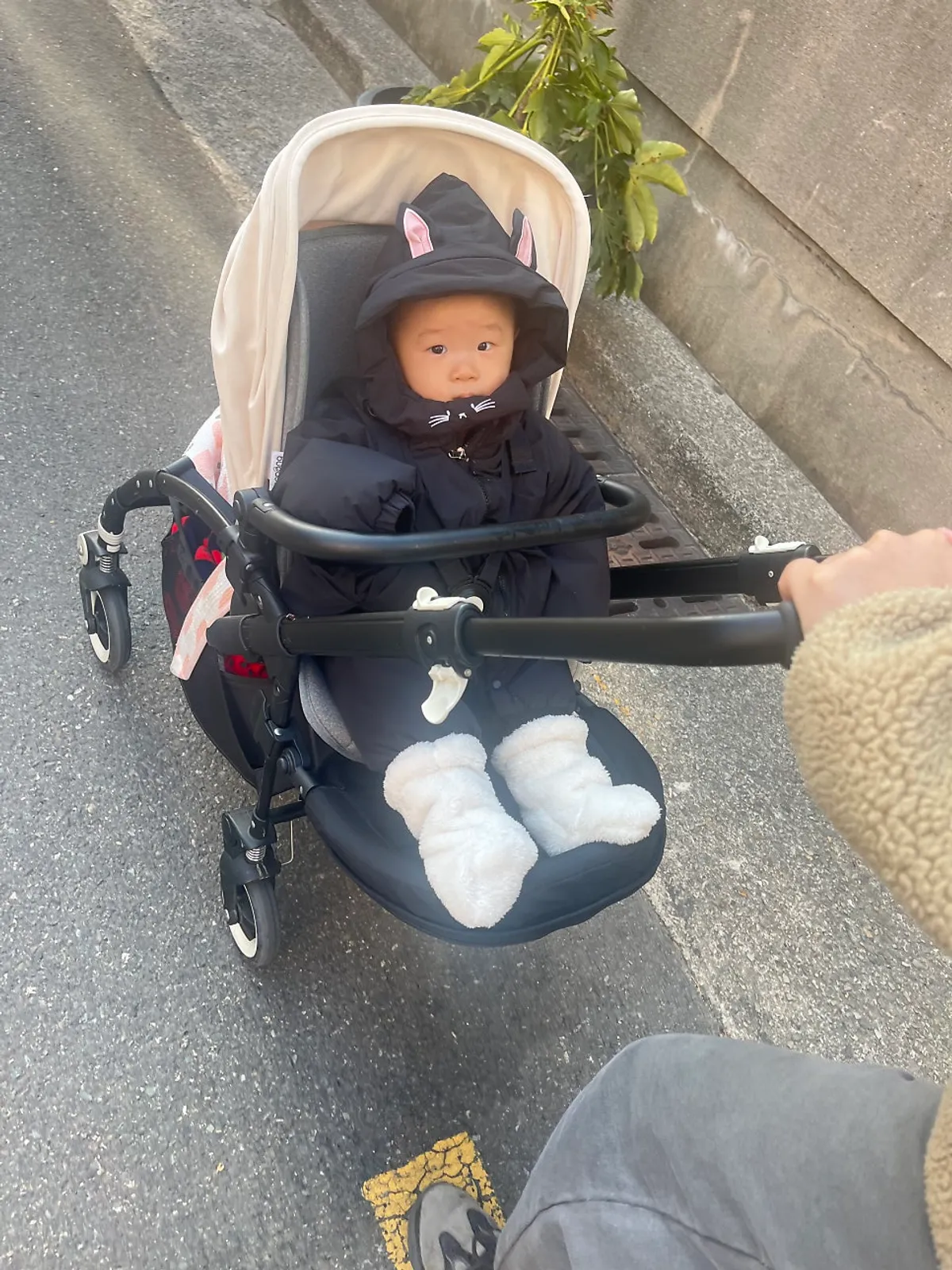Winter outing with baby foot warmers in sea winds