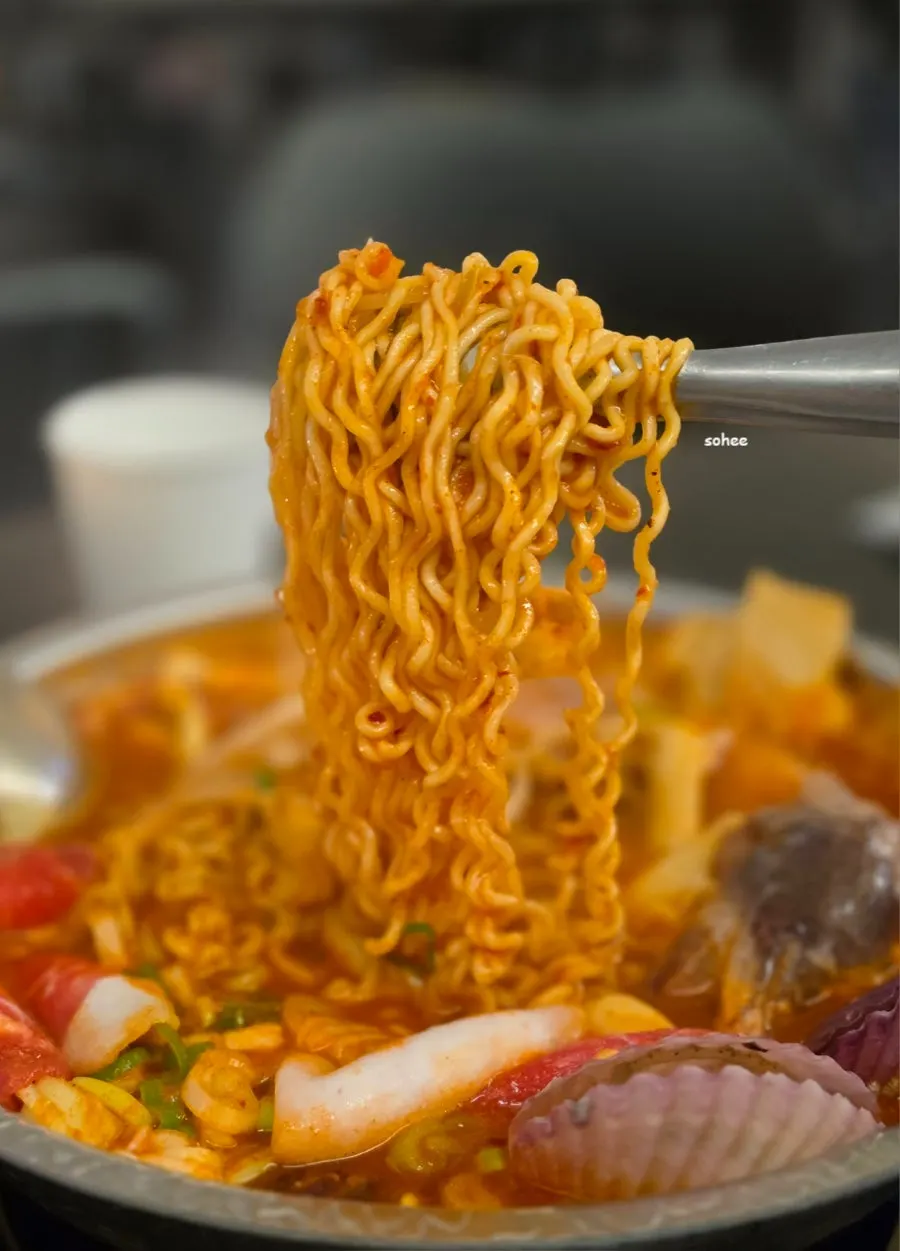 Close-up of the seafood tteokjjim packed with ramyeon noodles