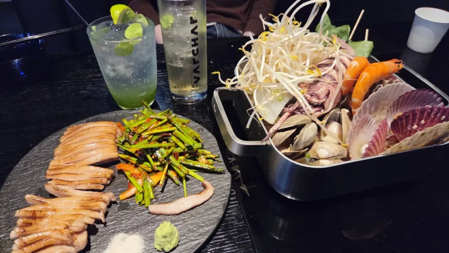 Full spread of bacha seafood jjim and pork jowl on the table