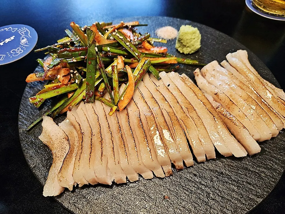 Sous vide pork jowl salad served with chive salad