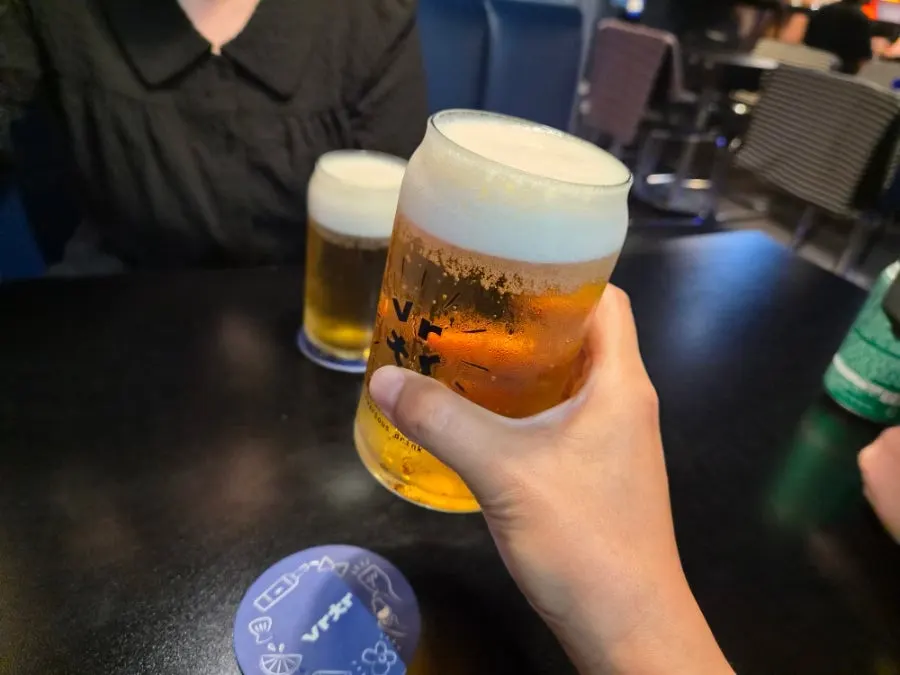 Table with cream draft beer and side dishes