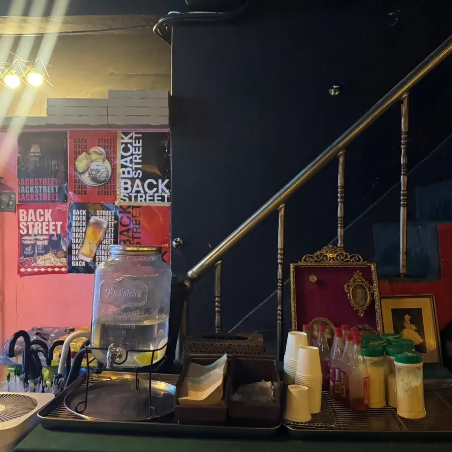 Entrance stairs leading down to basement-level Backstreet Pizza