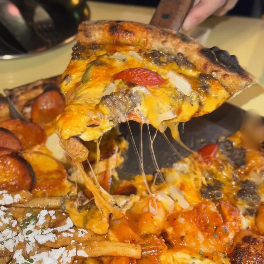 A slice of pizza with cheese stretching