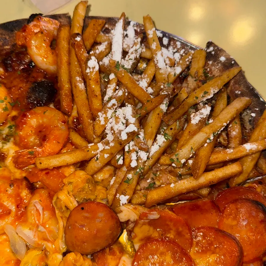 Slice of shrimp pizza topped with shrimp