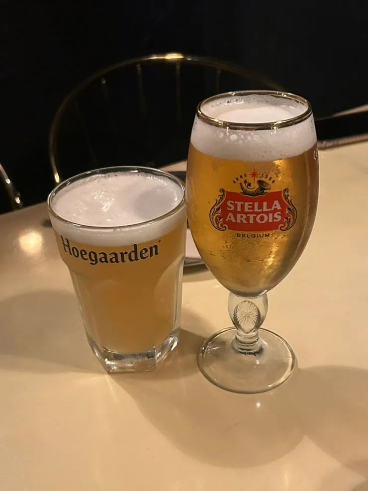 Two draft beers, Stella and Hoegaarden