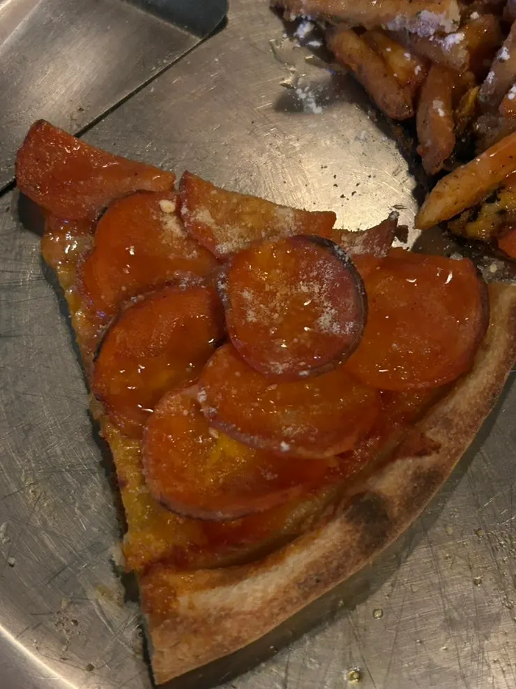Pizza crust dipped in garlic dipping sauce