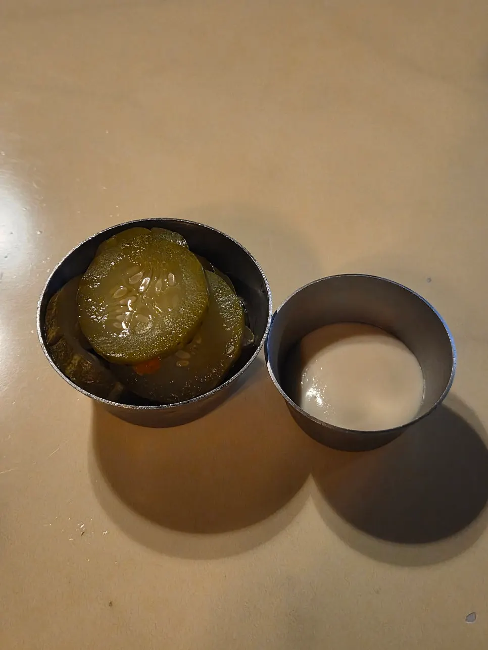 Pickles and garlic sauce served before the pizza