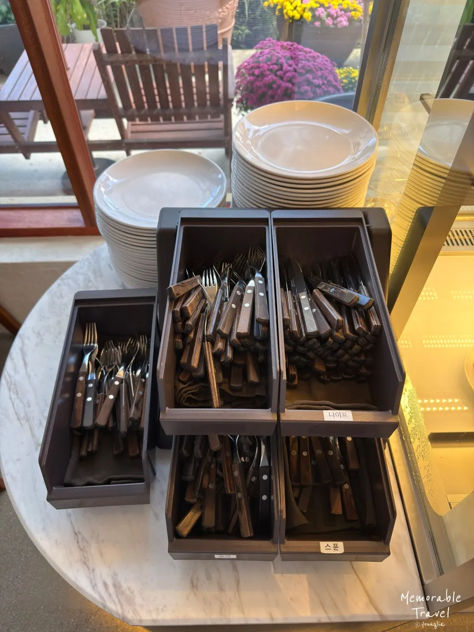 Self-serve corner with plates and cutlery