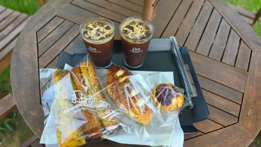 Iced coffee and bread on an outdoor table