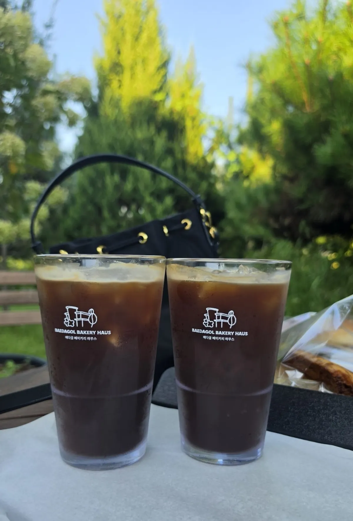 Iced coffee with the garden in the background
