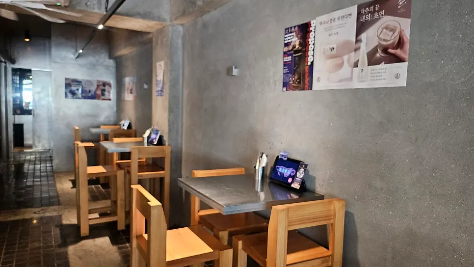 Interior of Bada Yakbang with wood-tone chairs and black tables