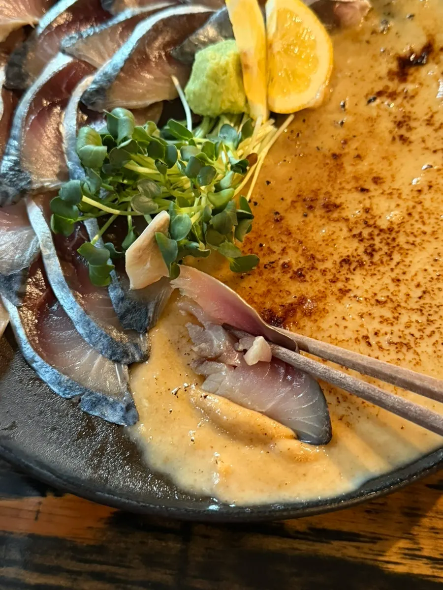 A springy, plump piece of mackerel sashimi
