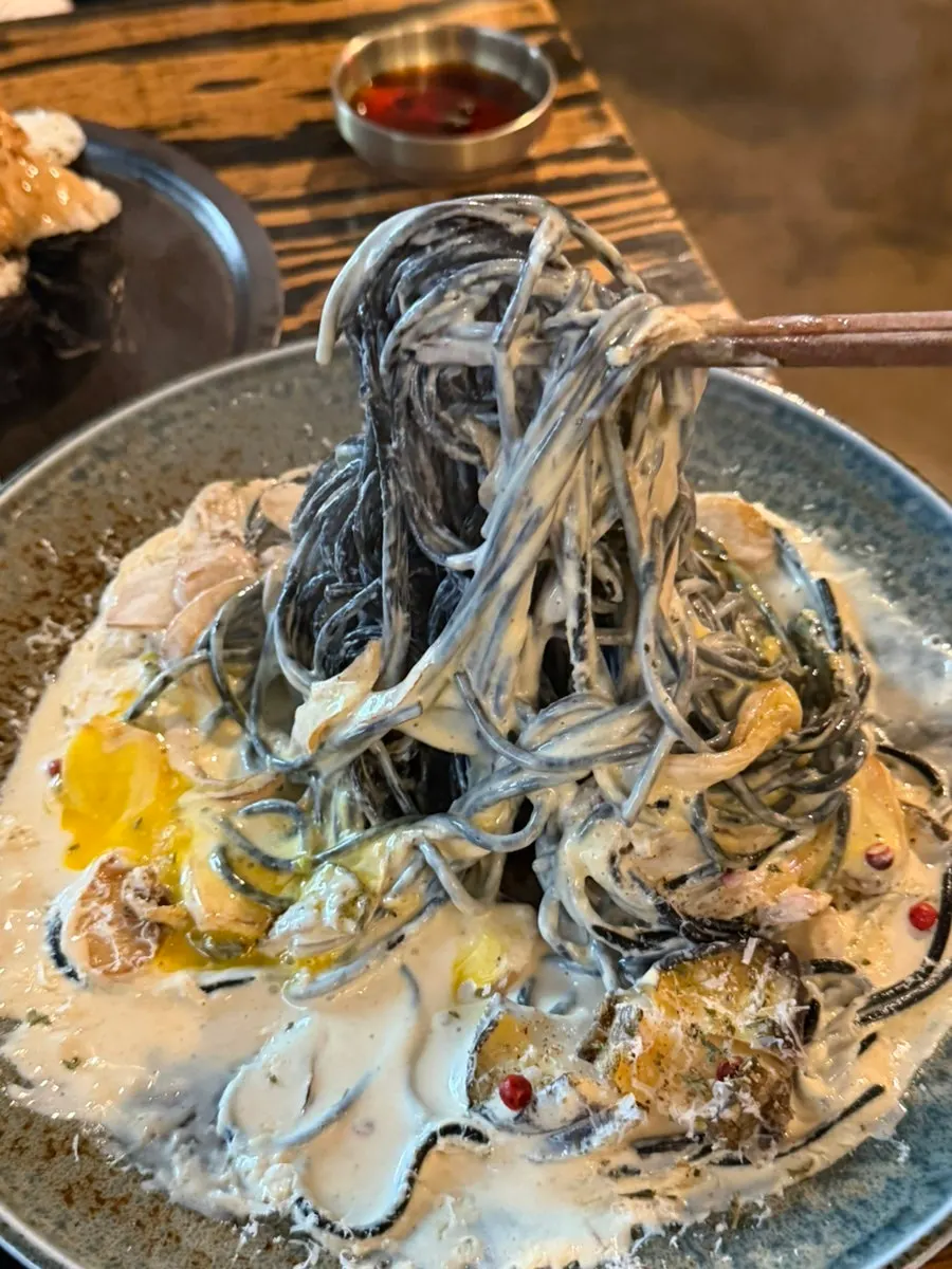 Noodles coated in the rich pasta sauce
