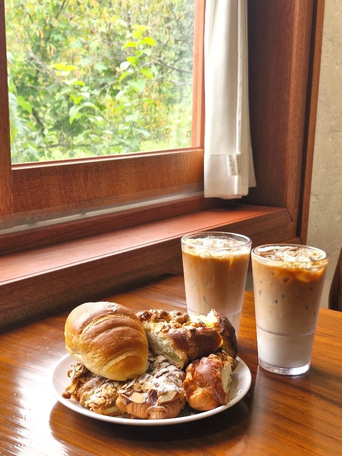 Cross-section of a salt bread cut in half, with a latte