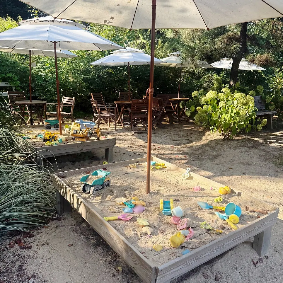 Sand play area for kids on one side of the garden