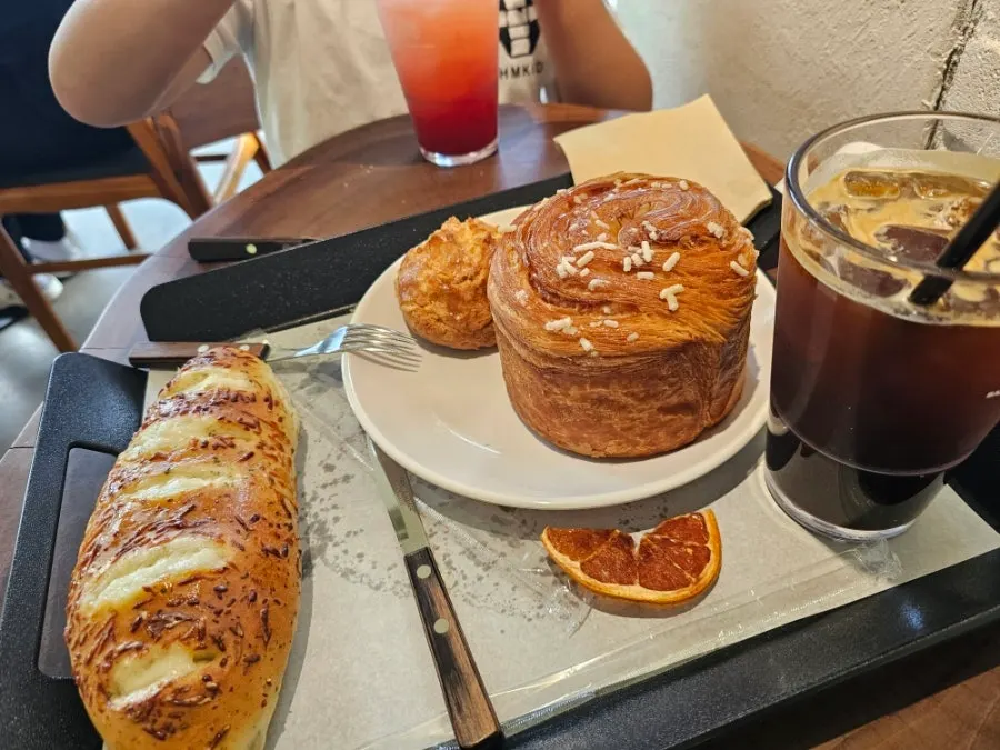 Iced coffee full of ice next to grapefruit ade