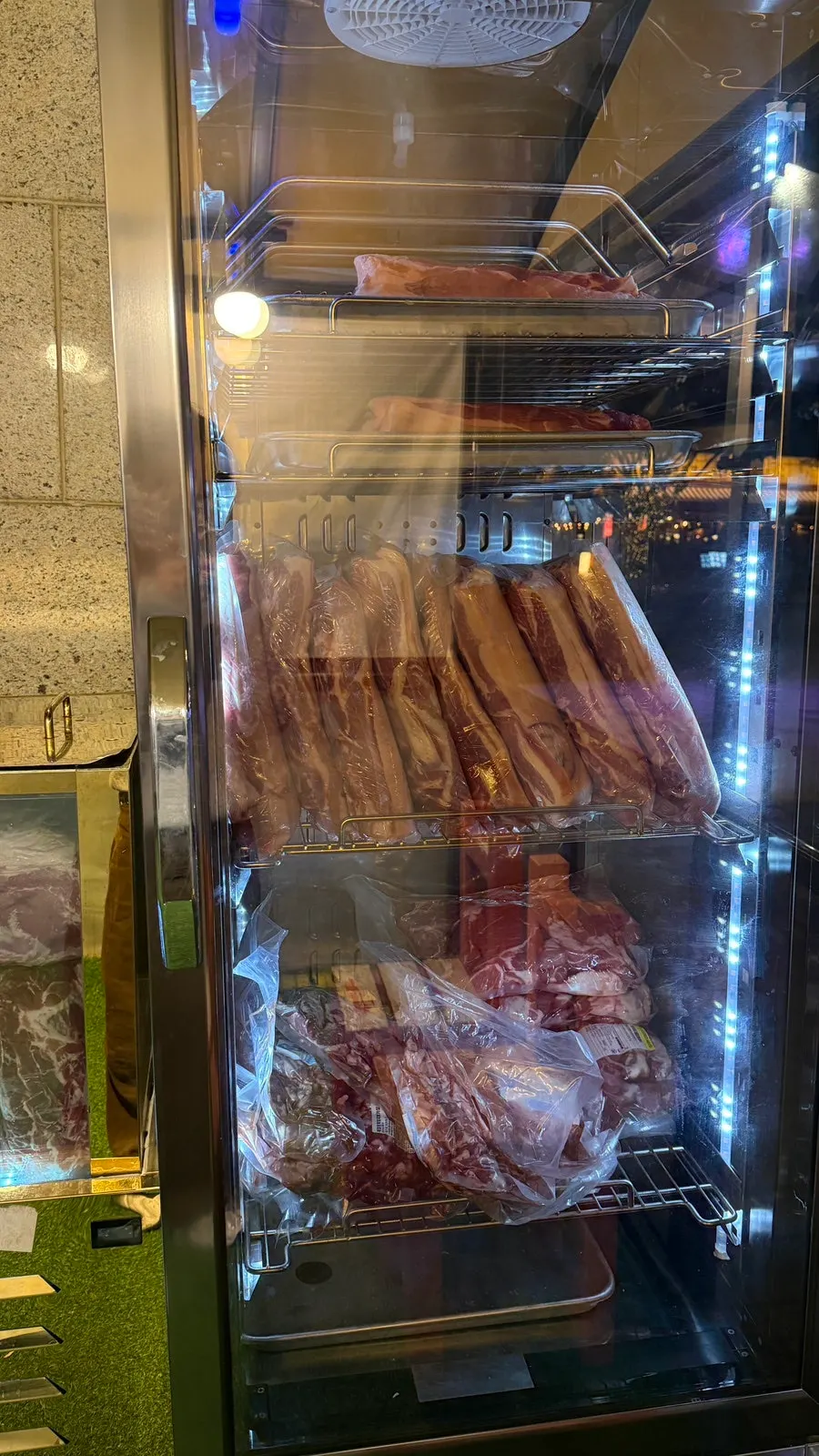 Water-aged meat and restaurant interior