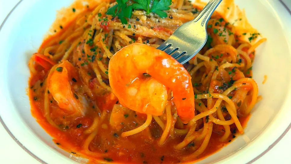 Shrimp pasta coated in tomato sauce