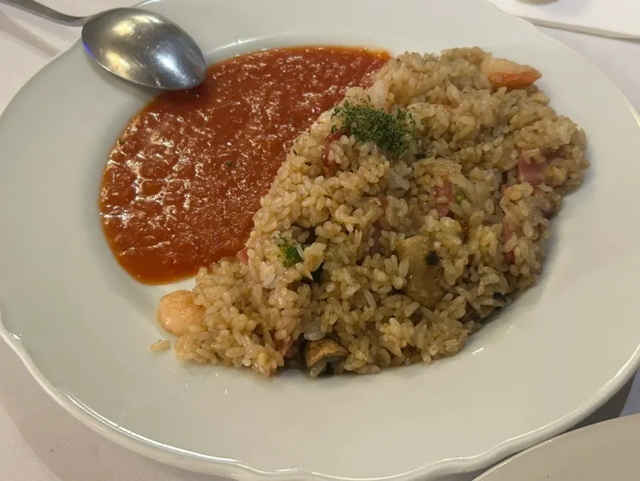 Shrimp pilaf served with tomato sauce