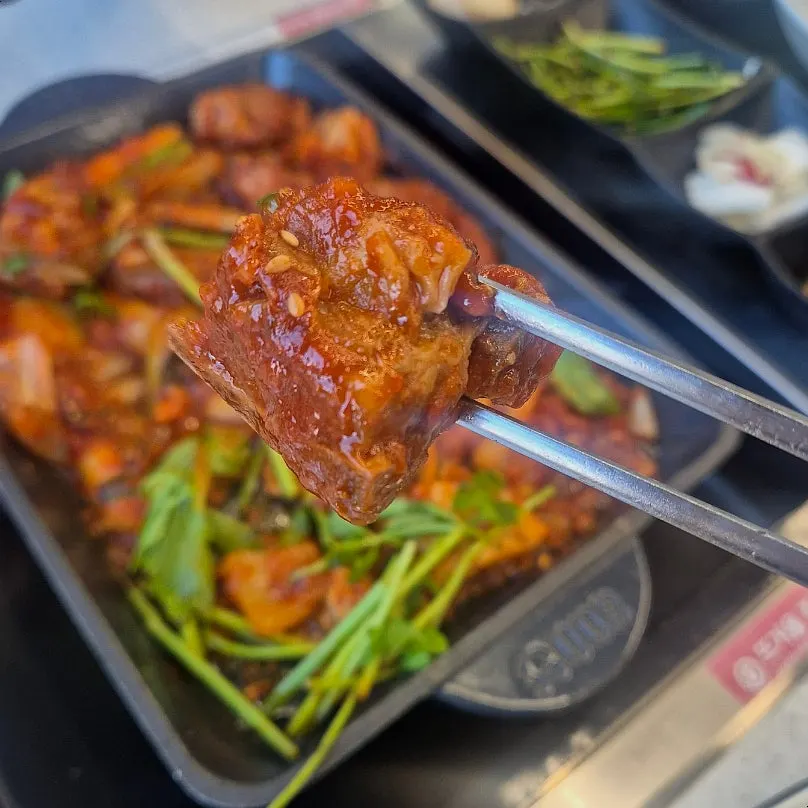 Braised pork ribs served onto a plate