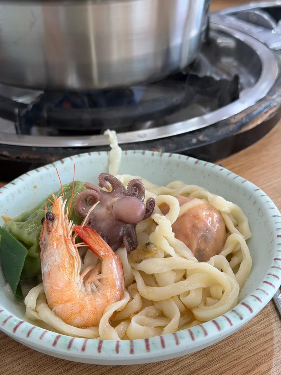 Octopus and vegetables cooking in the hot pot