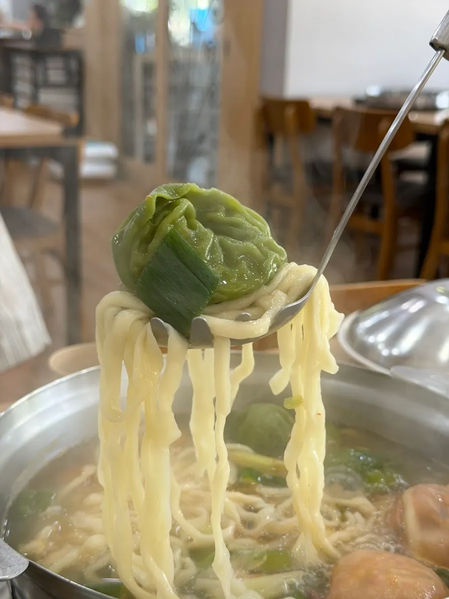 Wang mandu and seafood submerged in the broth