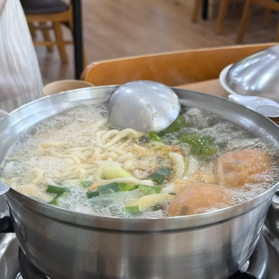 Kalguksu noodles simmering in the boiling broth