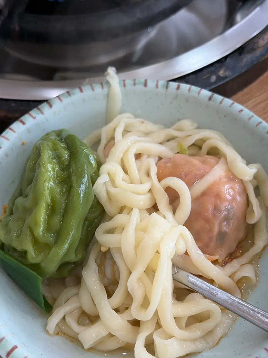 Kalguksu noodles lifted out, soaked in broth