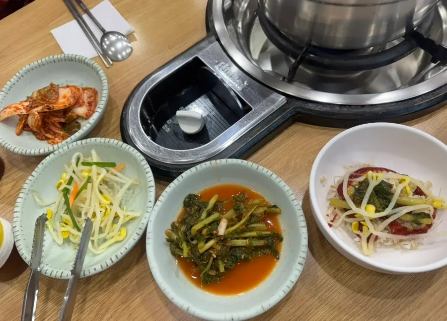 Table set for two with seafood mandu jeongol