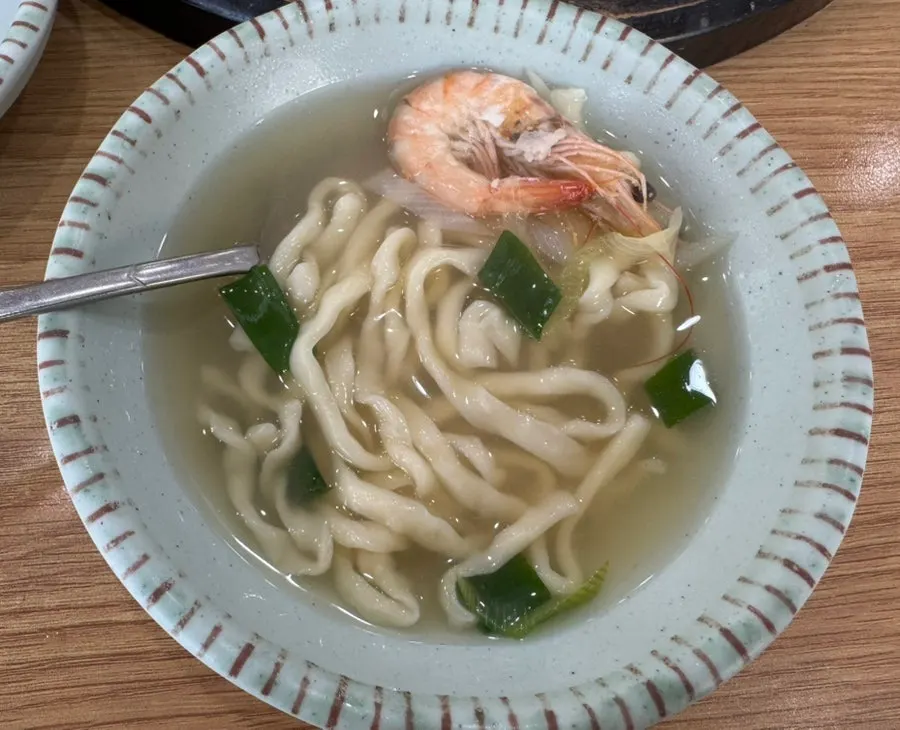 Bowl of chewy kalguksu noodles and dumplings served up