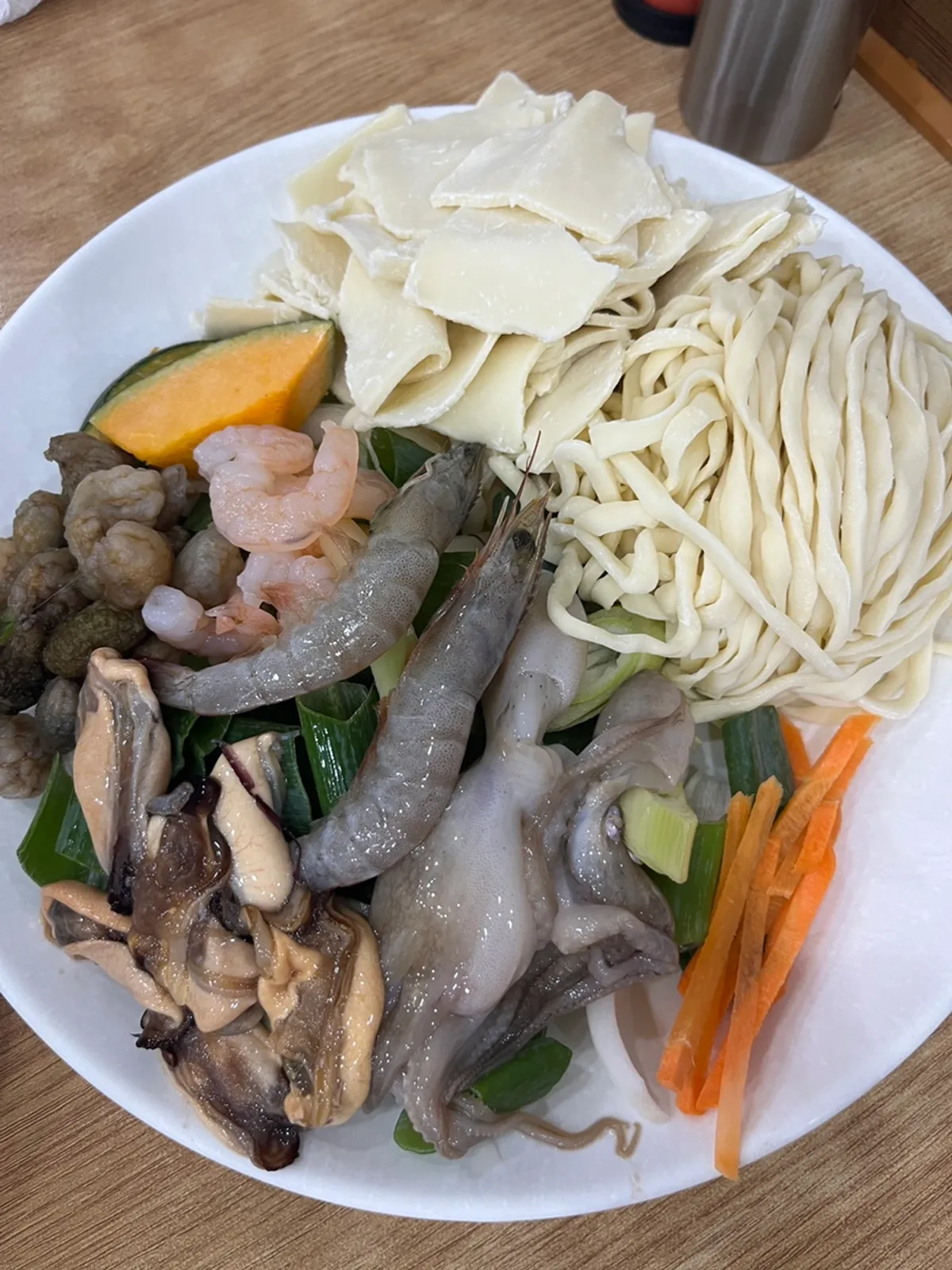 A full spread of seafood kalguksu at Baekcheongu Kalguksu in Dongbaek, Yongin