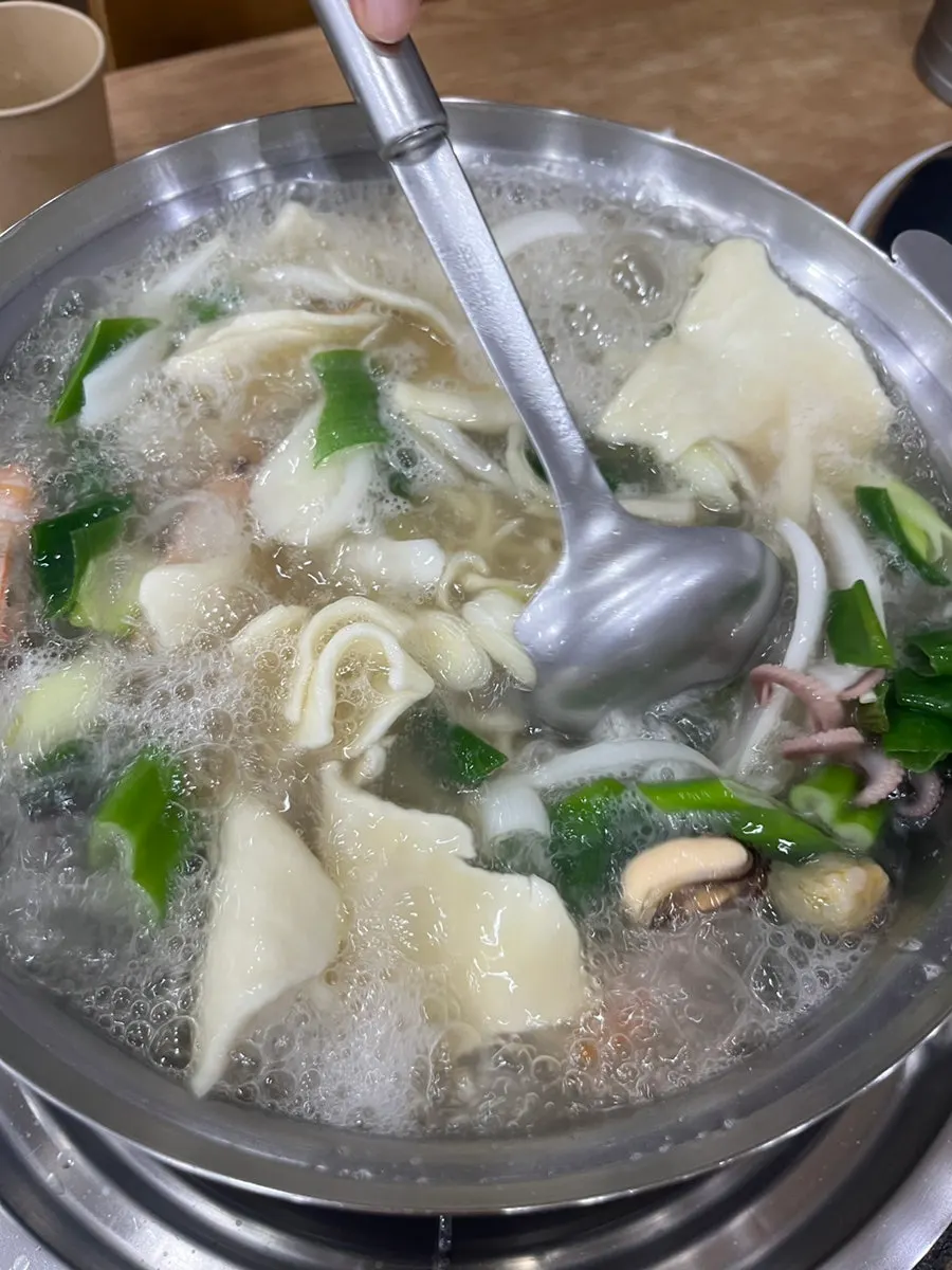 Seafood kalguksu simmering with the lid closed