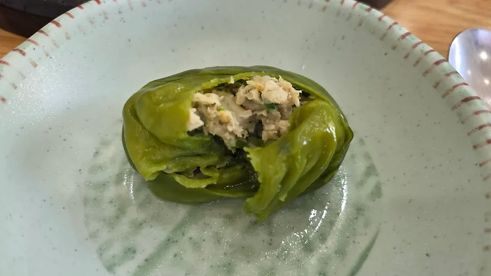 Plate of half-and-half steamed dumplings with white and green wrappers