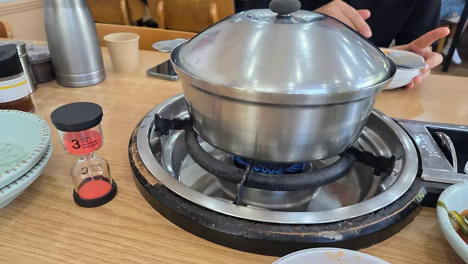 Pot of seafood kalguksu loaded with noodles and seafood