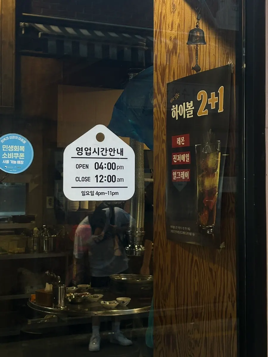 Sign board outside showing signature menu items and hours