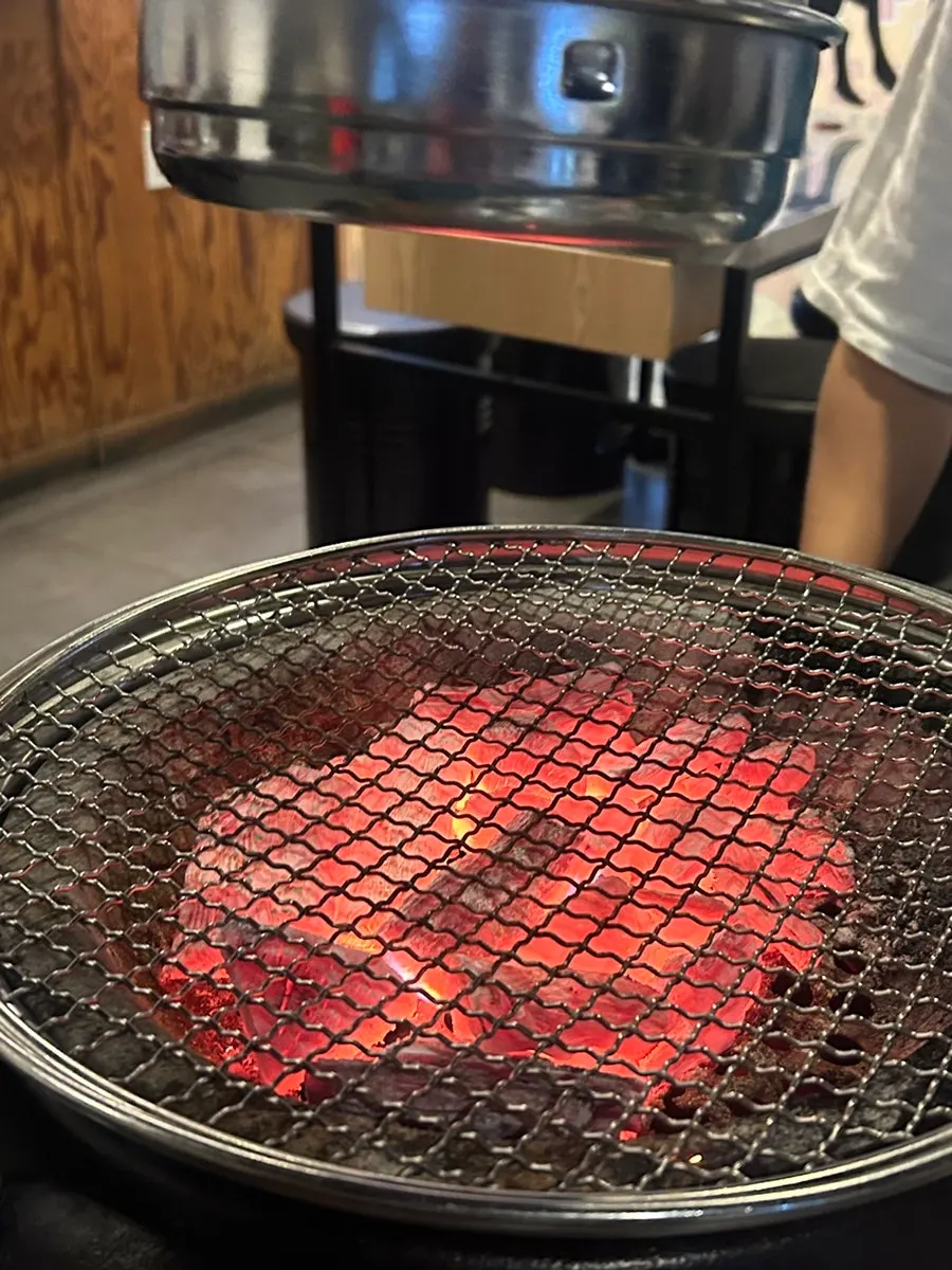 Gopchang and daechang grilling over charcoal