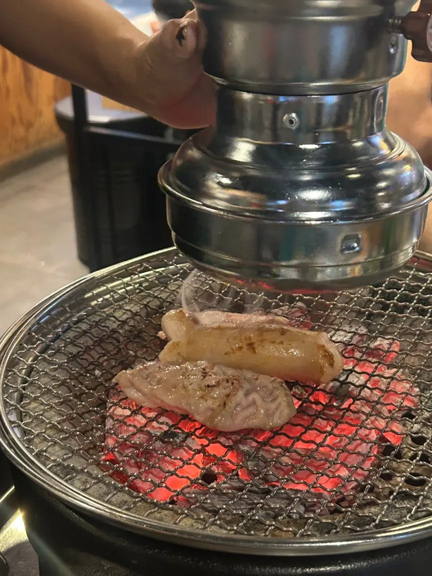 Extra order of daechang grilling over charcoal