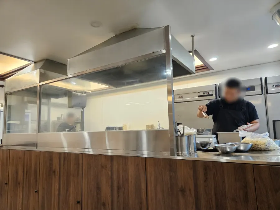 Half-open kitchen where cooking is visible