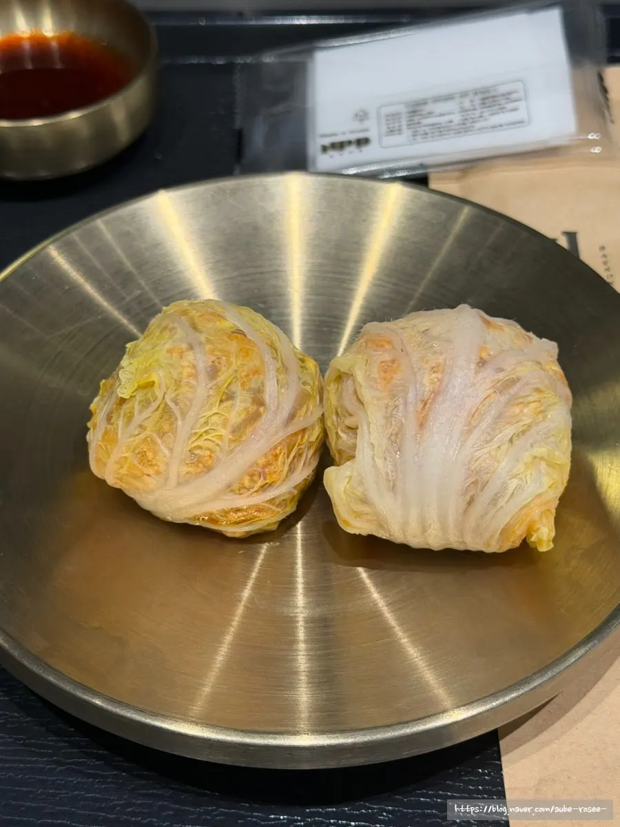 A spoonful of meat and broth lifted from the pork gomtang
