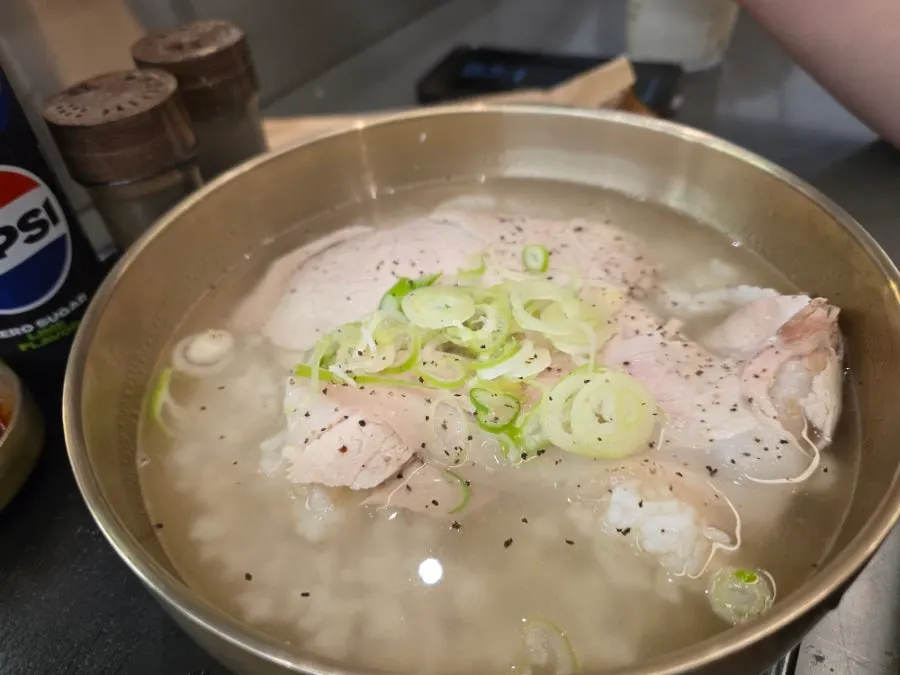 Rice mixed into the broth of Baekok's pork gomtang