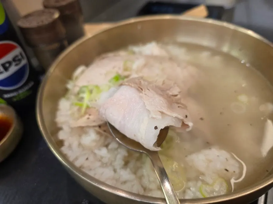 A spoonful of meat from the pork gomtang