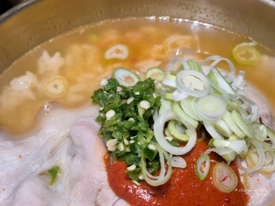 Inside of a cabbage dumpling packed with kimchi and meat