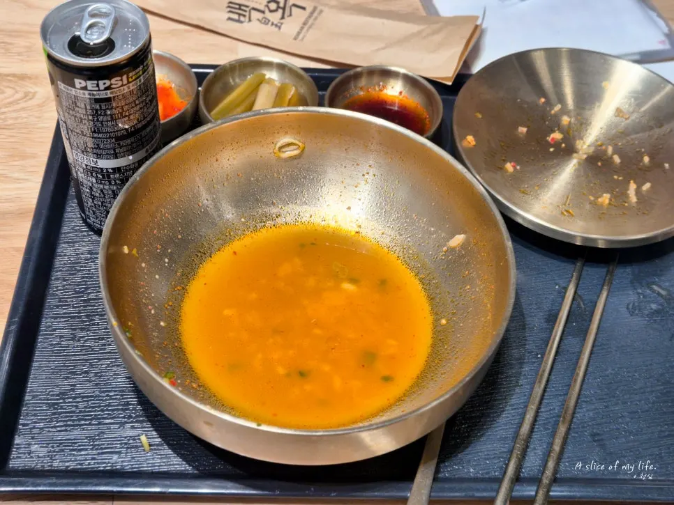 An empty bowl of spicy gomtang, broth and all