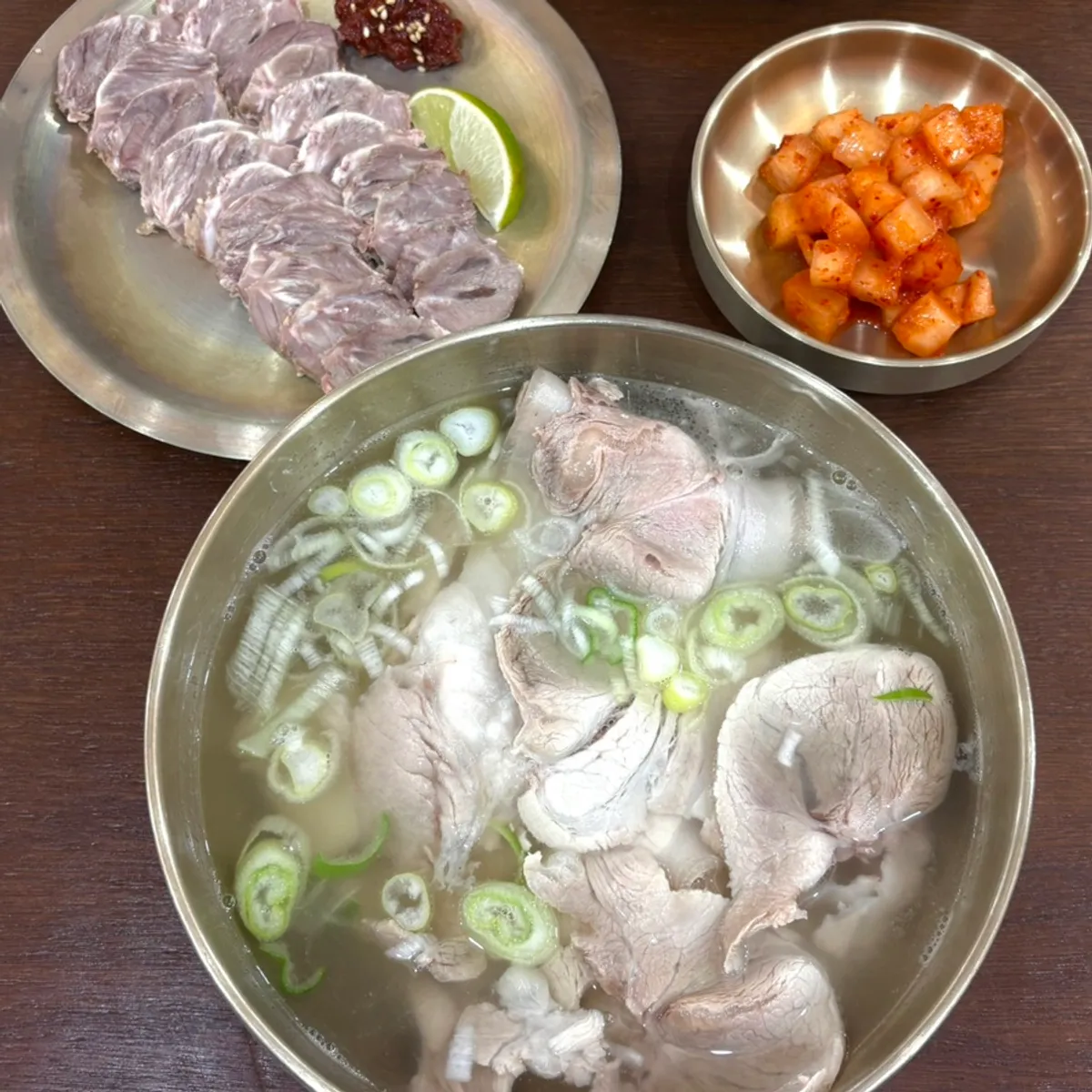 Table spread of Baekok Myeongdong's pork gomtang and cold pork slices