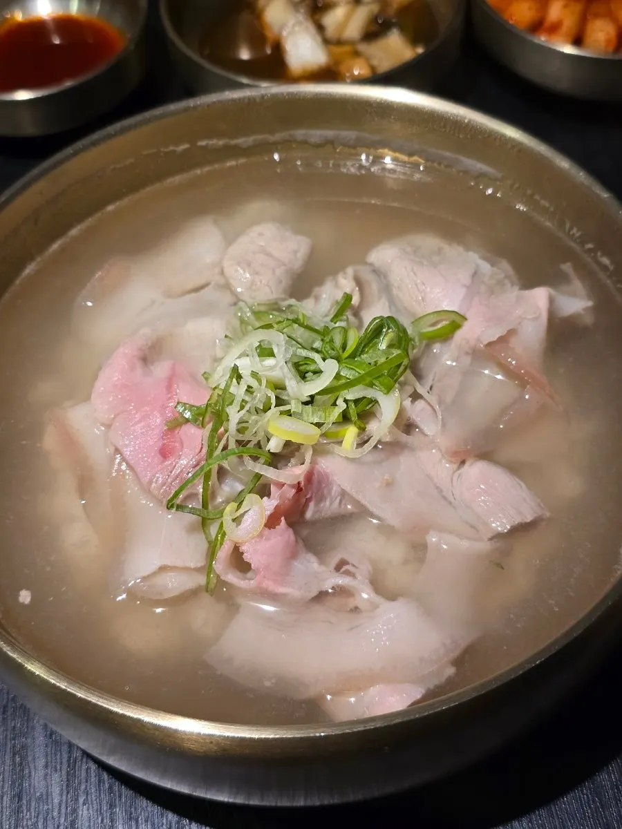 Table setting with mushroom-onion banchan and clear gomtang